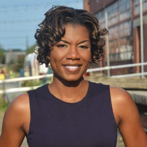 Color photo of Dr Nicki Washington a Black woman and leader smiling toward the viewer